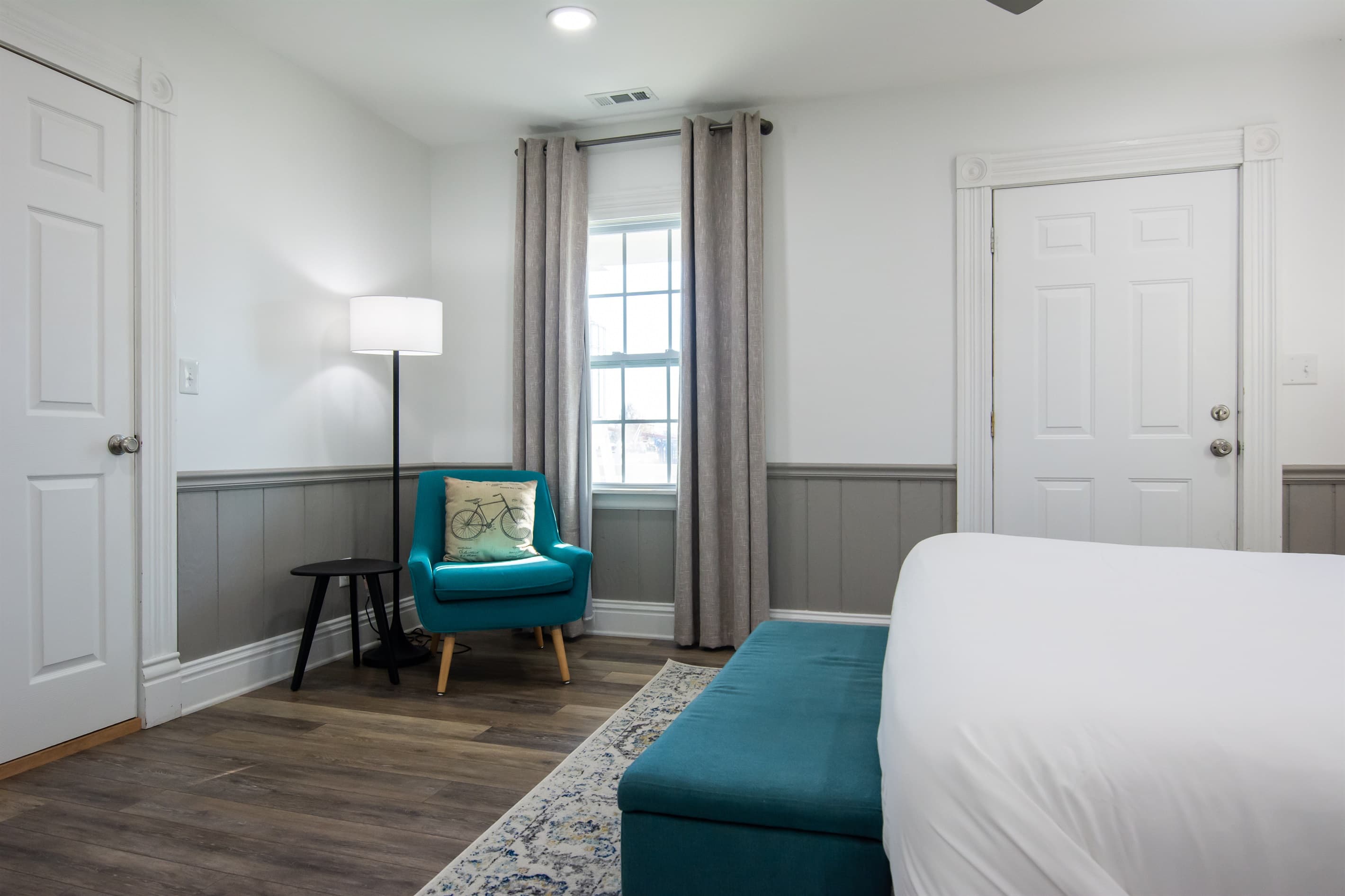 Extra seating in bedroom with side table at the Katy Haus.