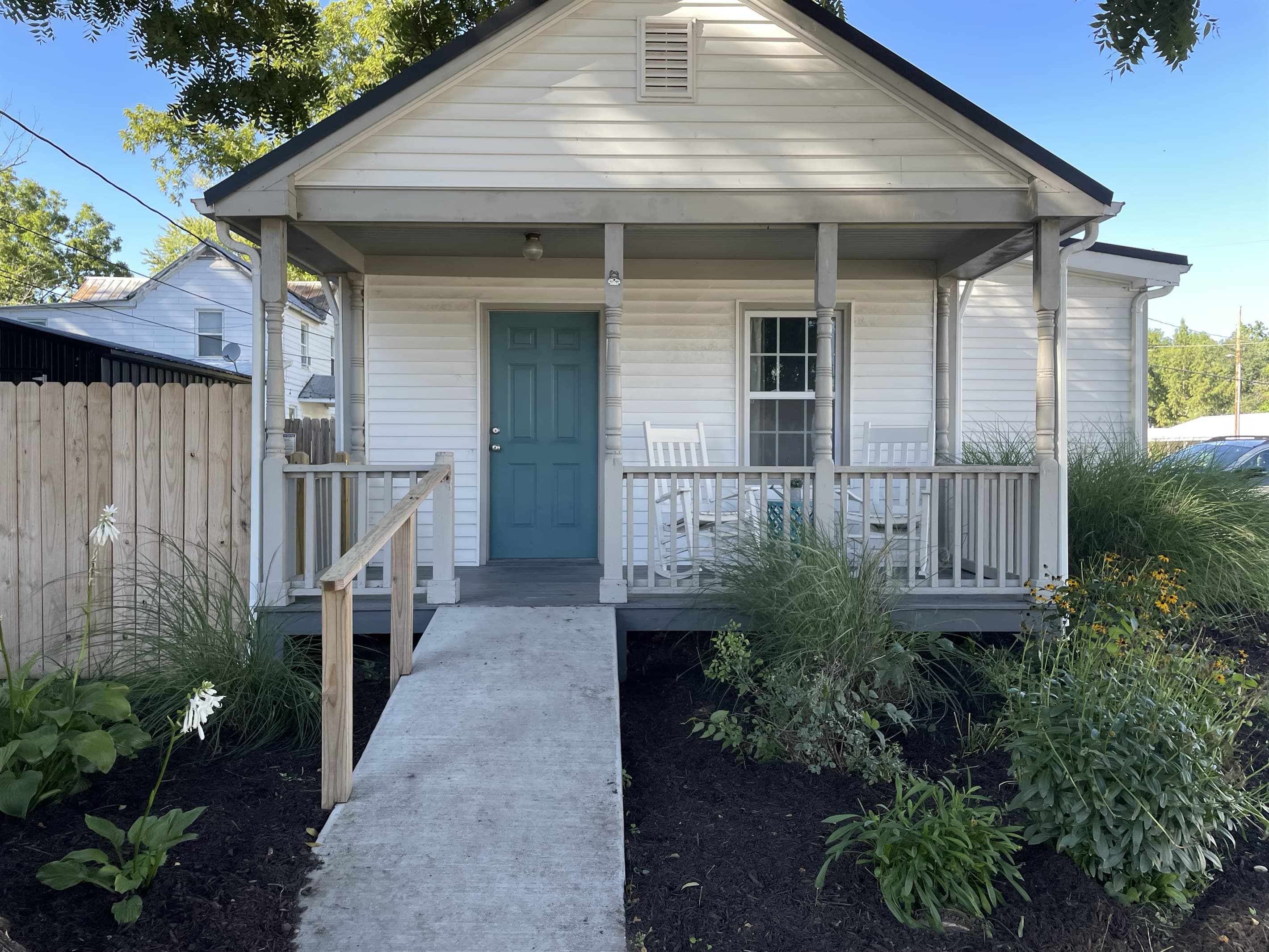 Concrete ramp to entrance at front