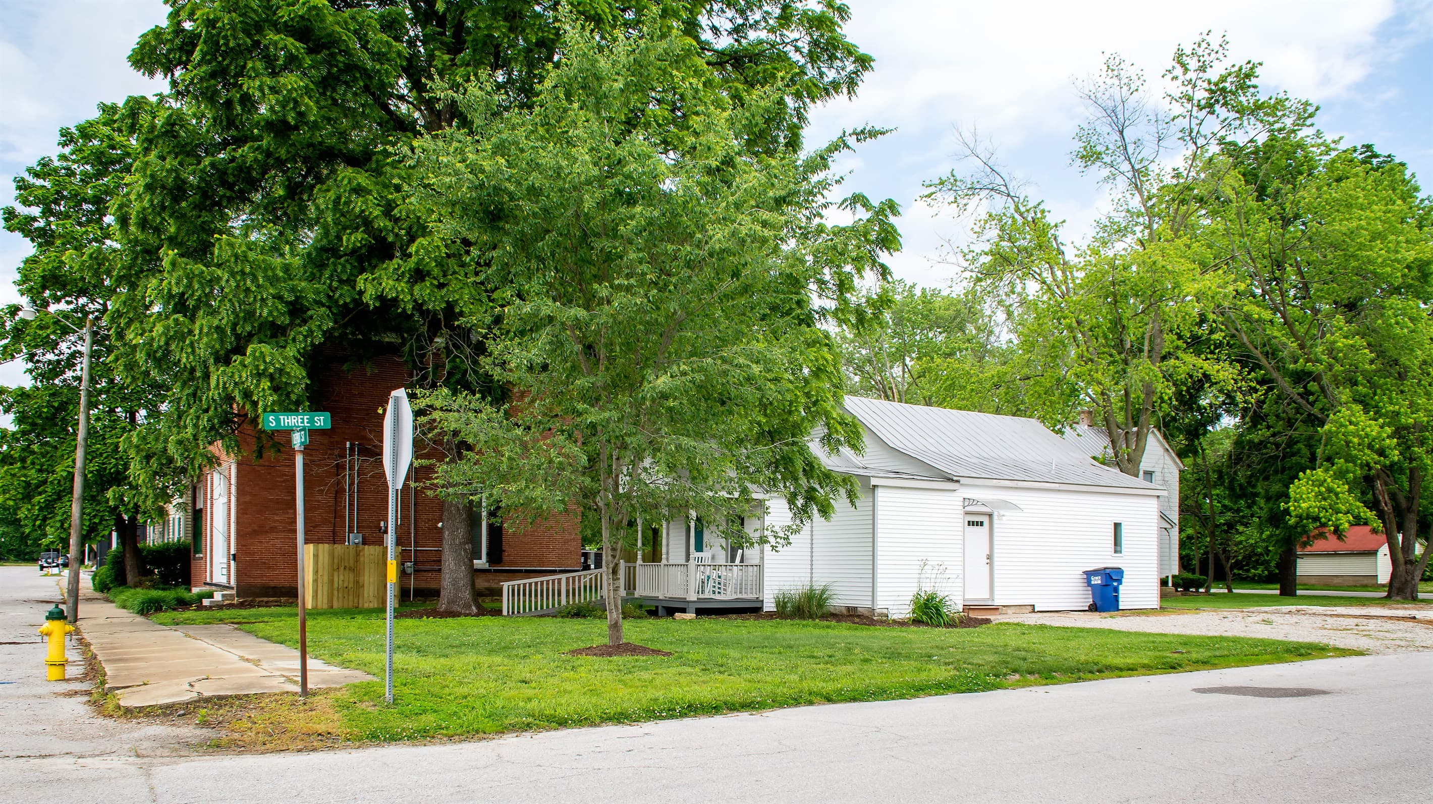 Parking pad on the right side of the house and main entry side door.