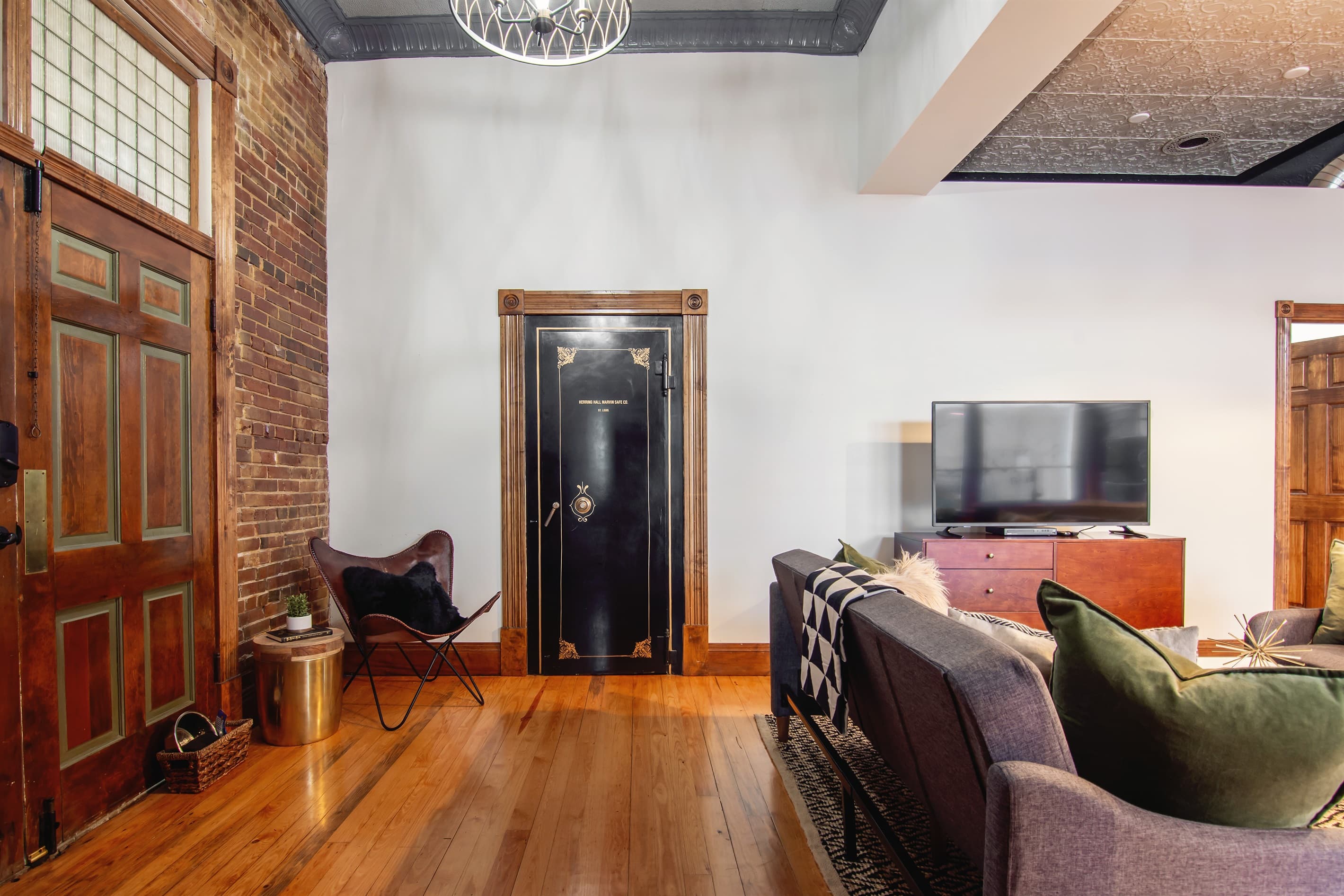 Main level spacious living area with entrance to two bathrooms. The original bank vault still in use but now as the laundry room with washer and dryer at the Bank Haus.