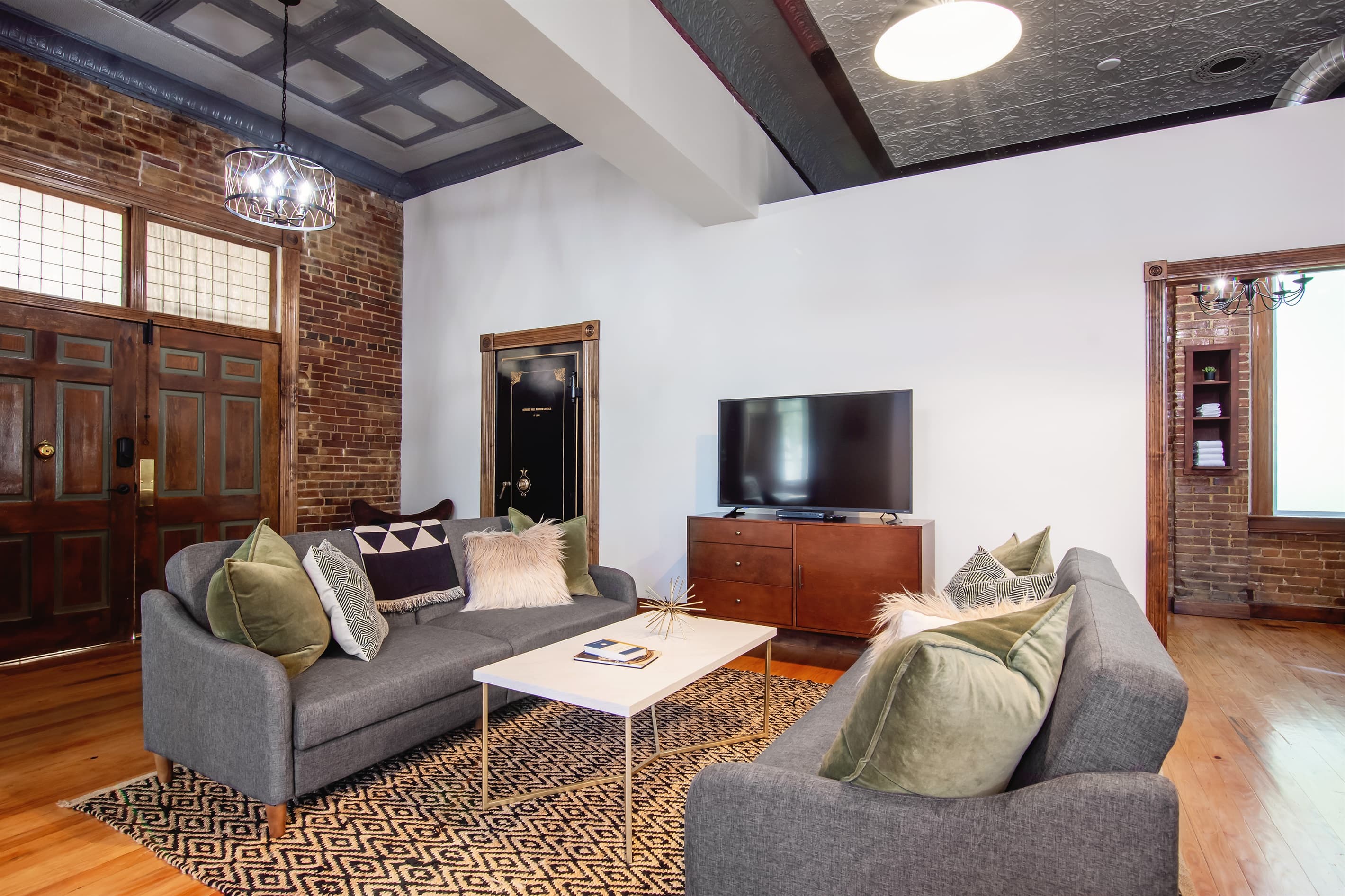 Main level spacious living area with entrance to two bathrooms. The original bank vault still in use but now as the laundry room with washer and dryer at the Bank Haus.