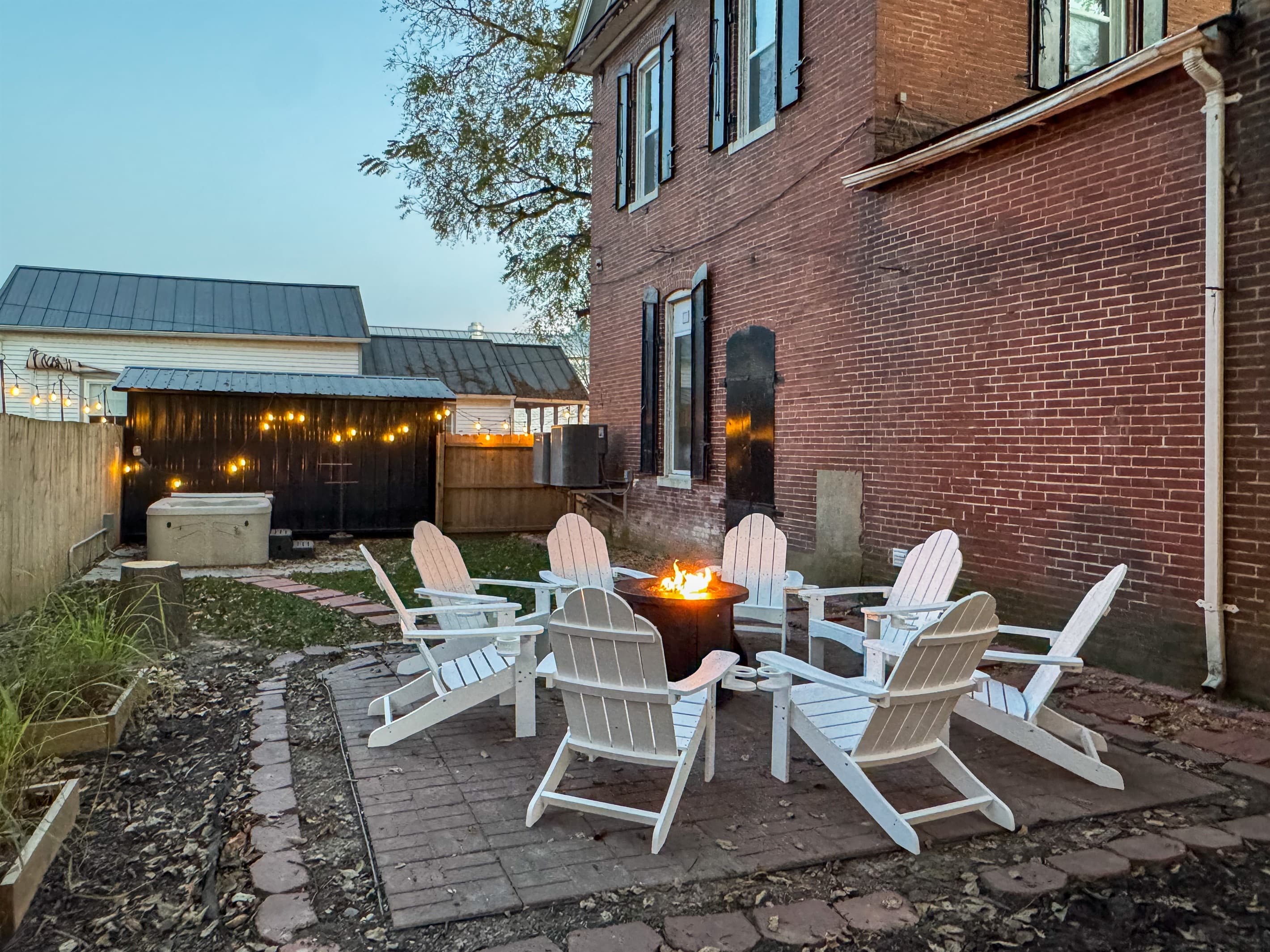 Private fenced in yard with hot tub and propane fire pit at the Bank Haus.
