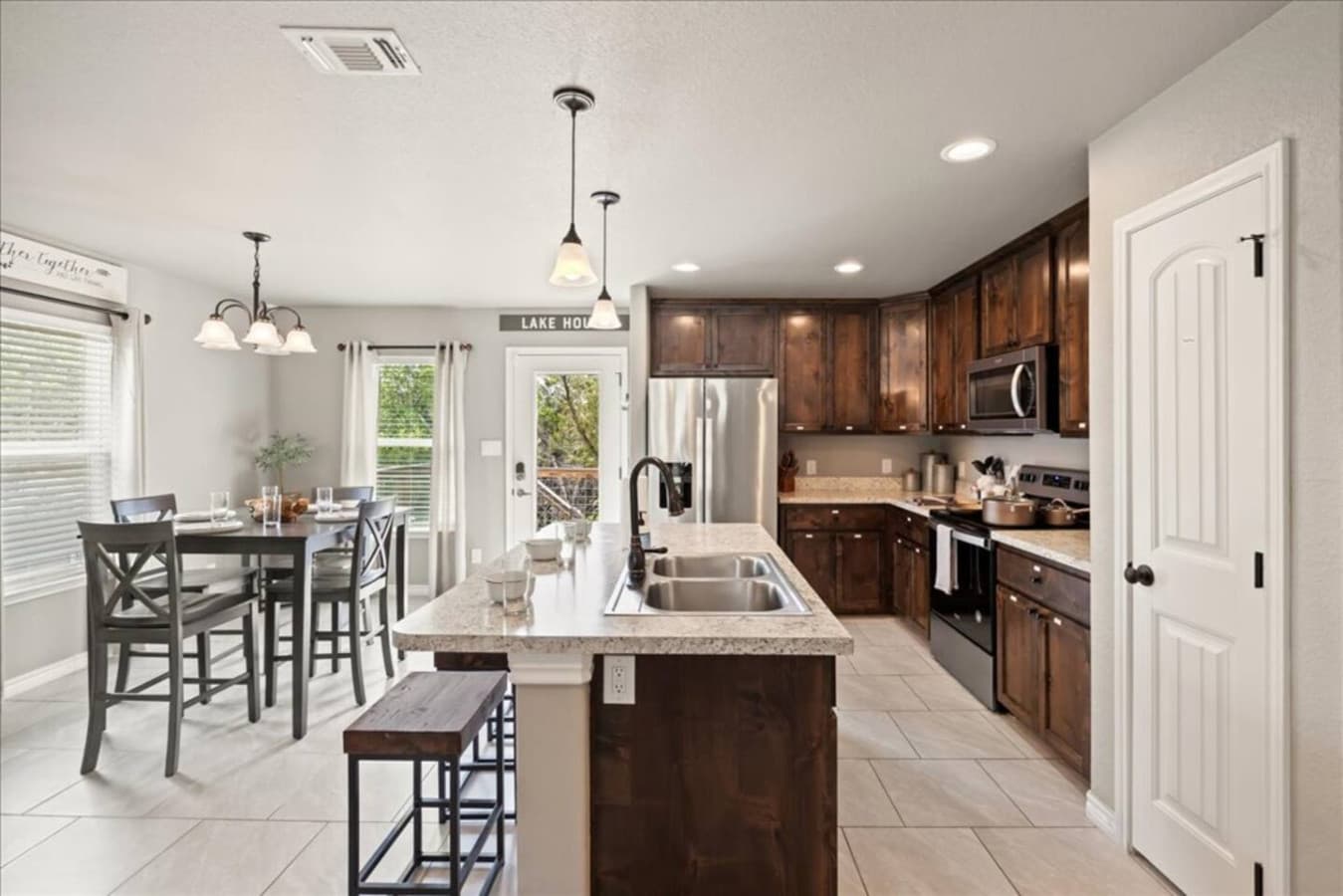 "Cook, dine, and connect in this fully stocked kitchen with granite countertops, stainless steel appliances, and plenty of seating. Whether it’s a big breakfast before lake day or a cozy dinner in, this space makes mealtime easy and enjoyable!"