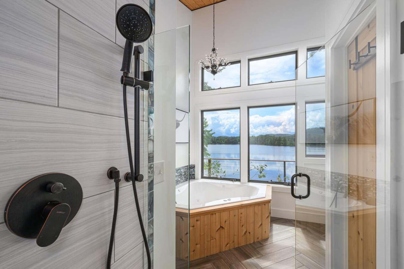 Primary bath: A deep soaking tub and spa-like shower are perfectly positioned to take in beautiful water and mountain views, turning everyday routines into moments that feel indulgent, calming, and unforgettable.