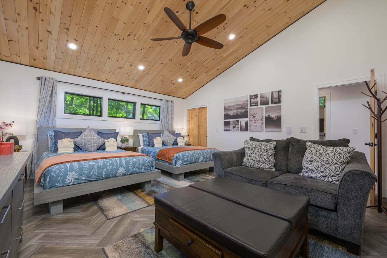 BEDROOM 3: Set on the 1st floor, this inviting bedroom features 2 queen beds, a cozy loveseat, and direct access to the waterfront. It’s a comfortable, flexible retreat for families or friends who want space to relax and recharge.