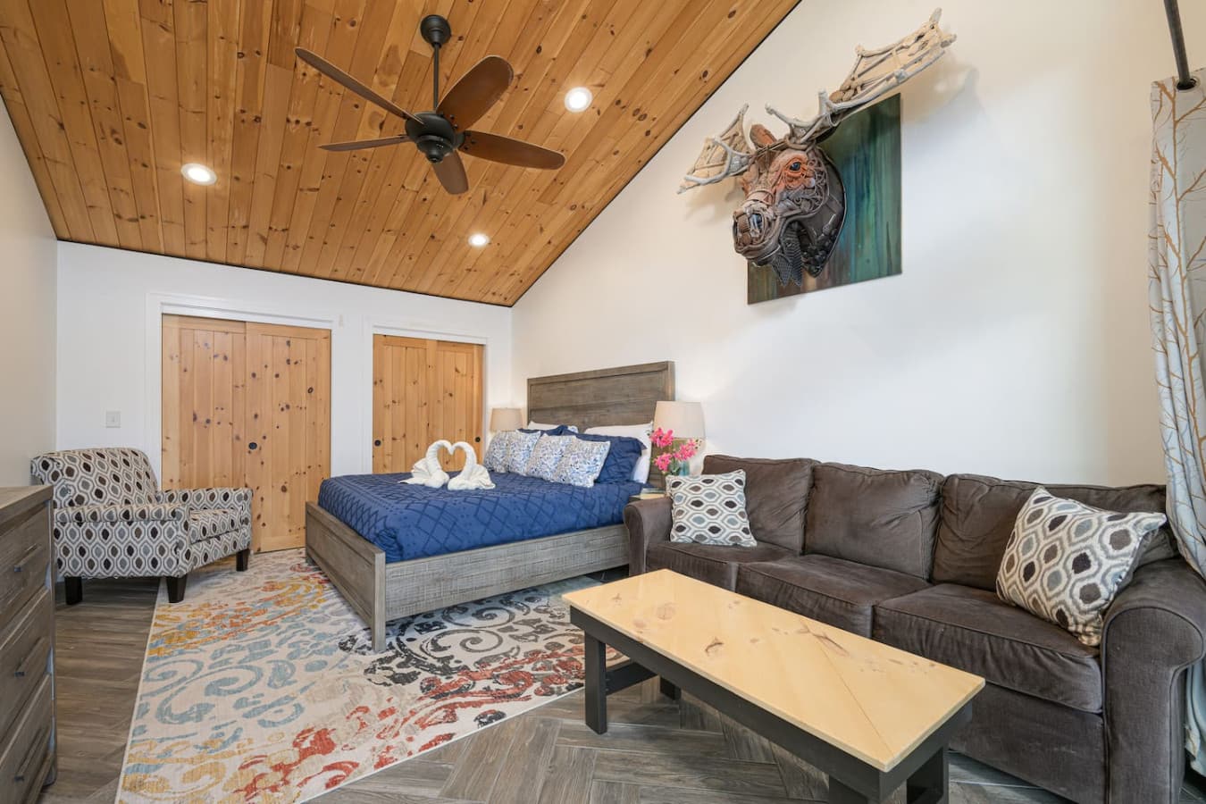 The spacious layout gives this bedroom a true suite feel, with a king bed, full sofa, coffee table, dresser, closet, and TV. It’s the kind of room where you can unpack, settle in, and actually enjoy lingering a little longer.