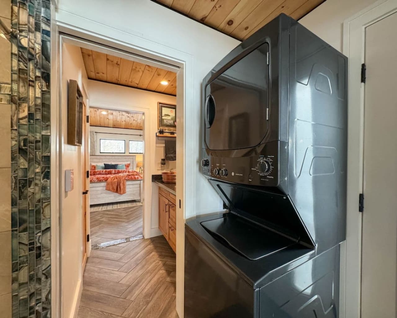 Coming in from the water is easy here—the exterior door allows guests to access the shower & toilet directly, helping keep sand and water out of the house. The adjacent laundry area includes complementary washer, dryer, Tide PODs, and dryer sheets.
