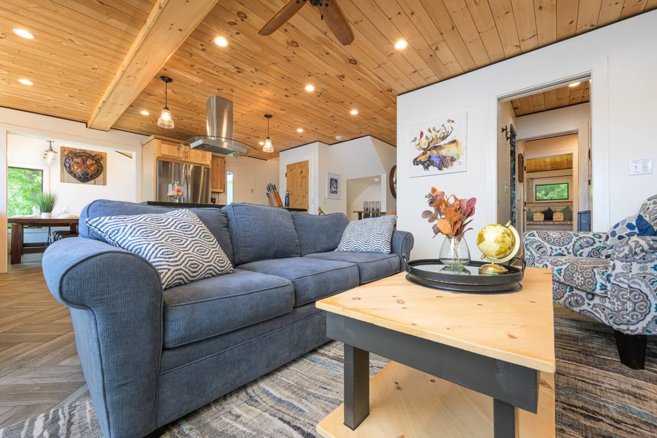 Spacious, open-concept living room made for together time—right next to the kitchen, with deck access and waterfront views that make you want to stay one more day.