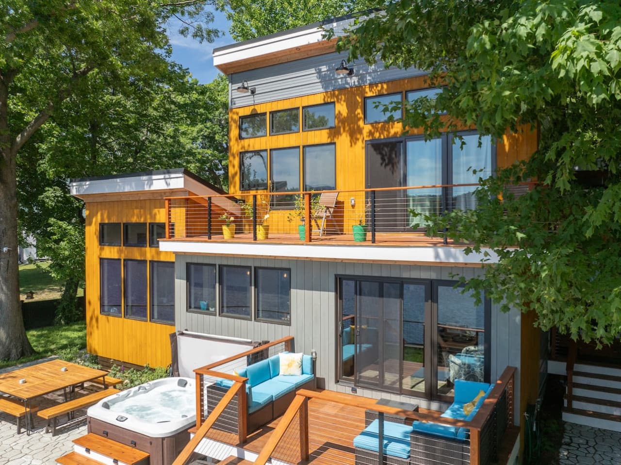 The home’s tiered decks create a true indoor-outdoor retreat, with dedicated spaces to soak in the hot tub, lounge in the sun, and step inside with ease between meals, conversation, and time on the water.