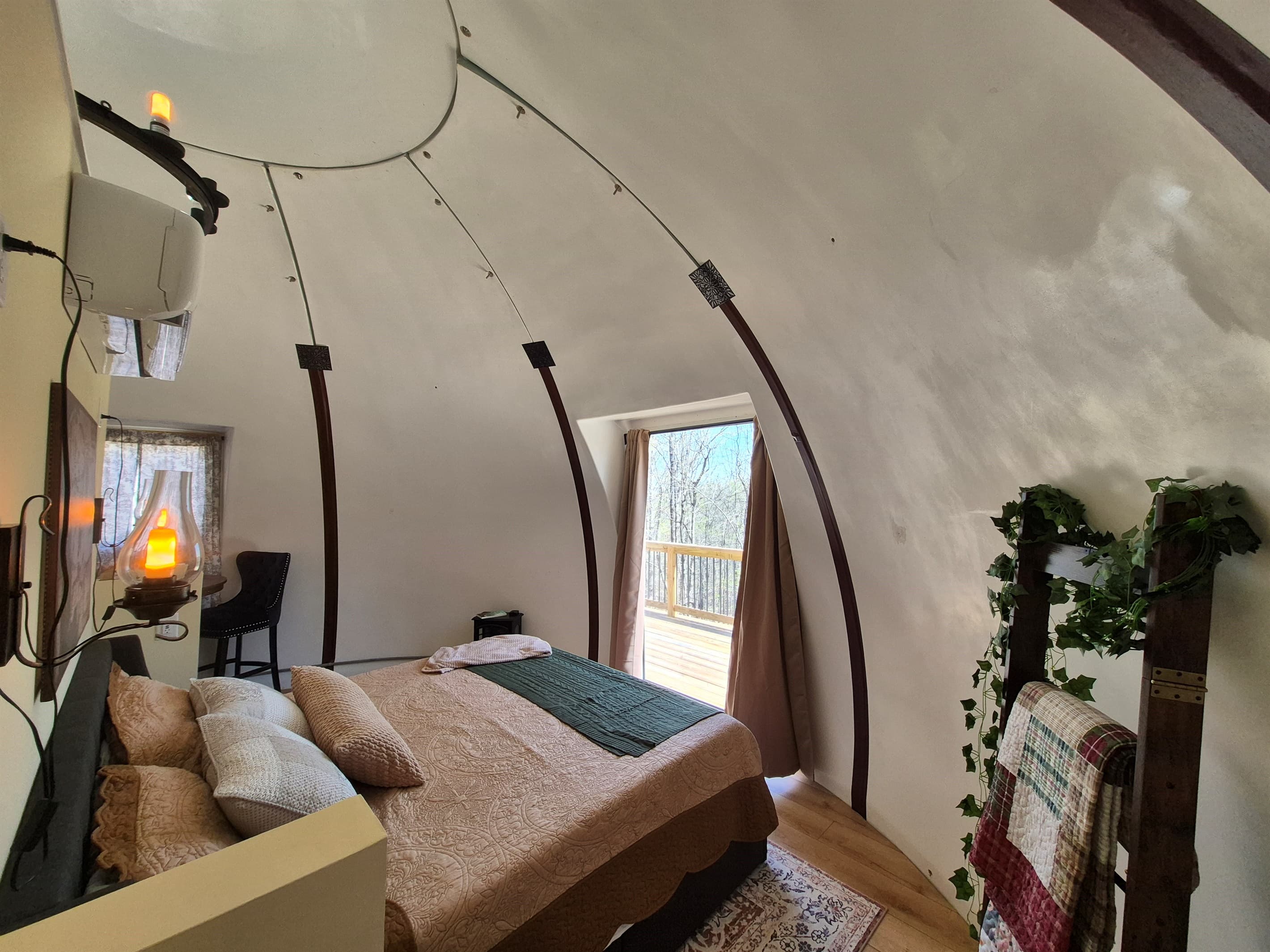 Cozy king sleeping area with adjacent ensuite bathroom with standard toilet and shower