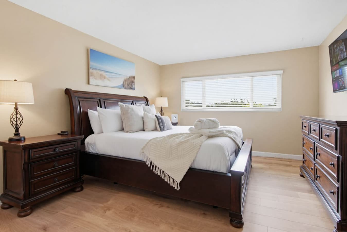 Cozy bedroom w/ plush bed, warm tones & soft lighting for a restful night in