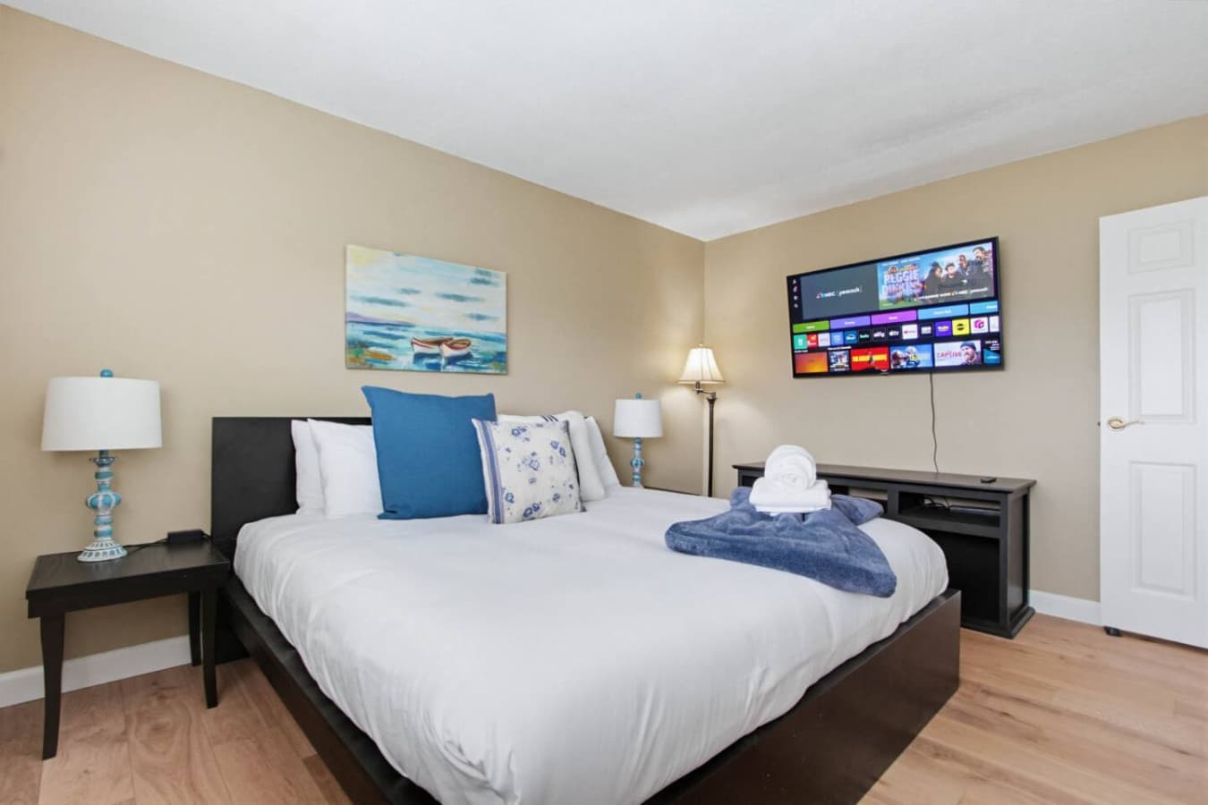 Comfortable bedroom w/ bed, soft linens & TV for relaxed evenings in
