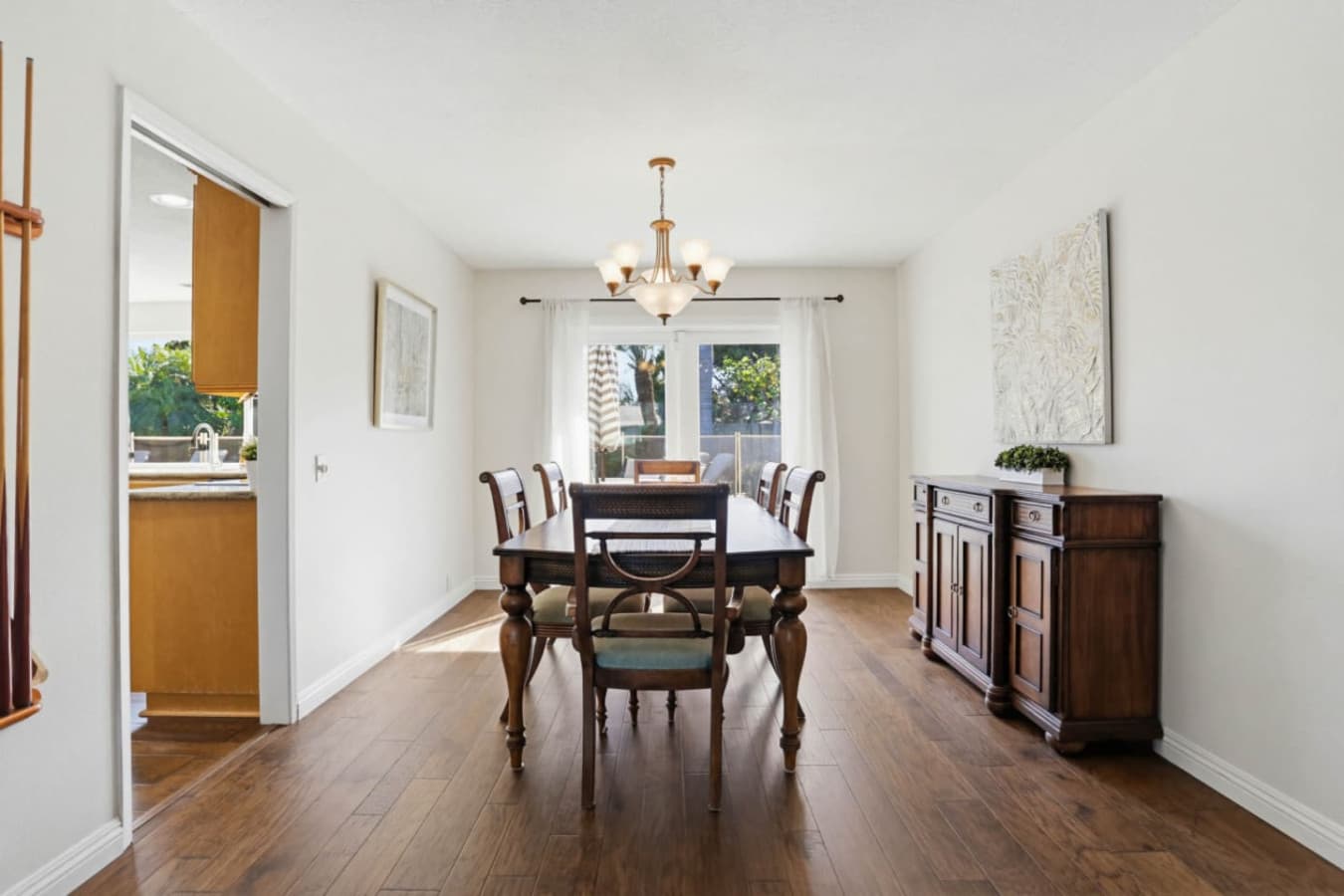 Dining room w/ classic table, chandelier & bright windows for shared meals