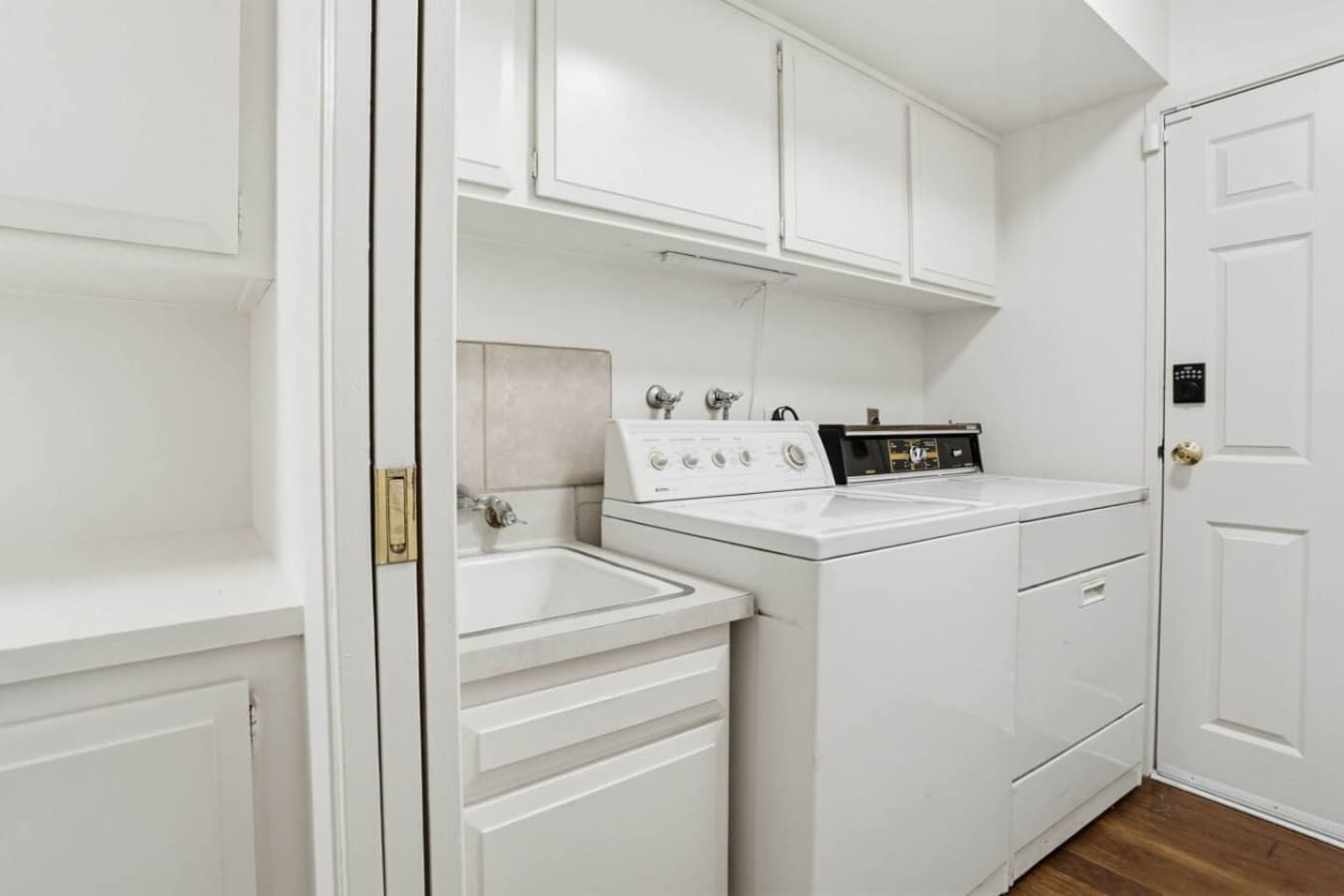 Clean laundry area w/ washer, dryer & storage for convenient mid-stay refresh