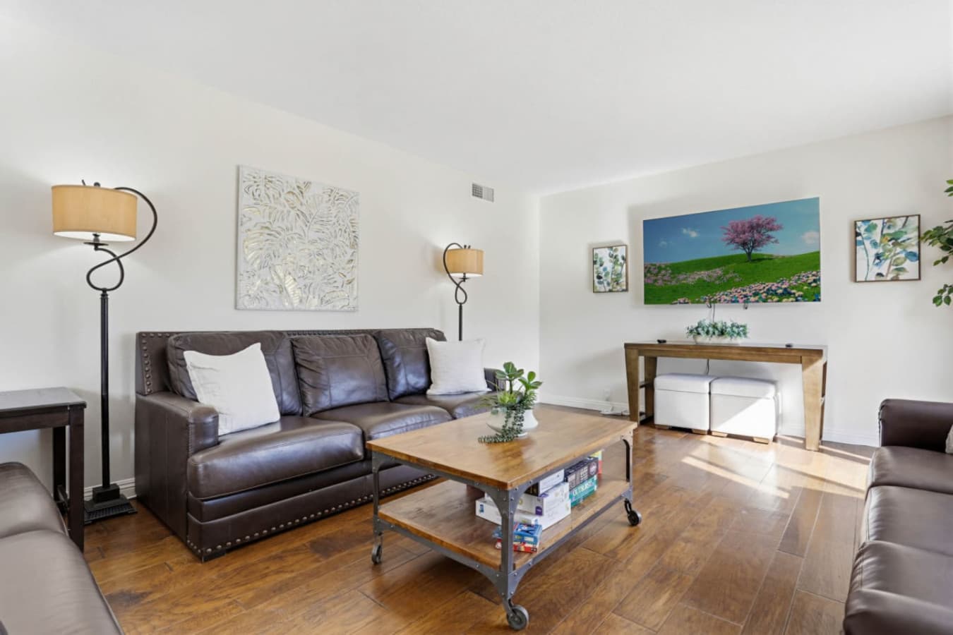 Comfortable living room w/ leather seating, coffee table & TV for laid-back lounging