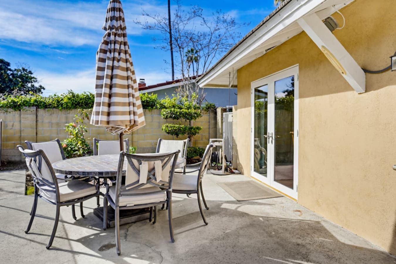 Outdoor patio w/ dining table, umbrella & space for relaxed meals in the fresh air