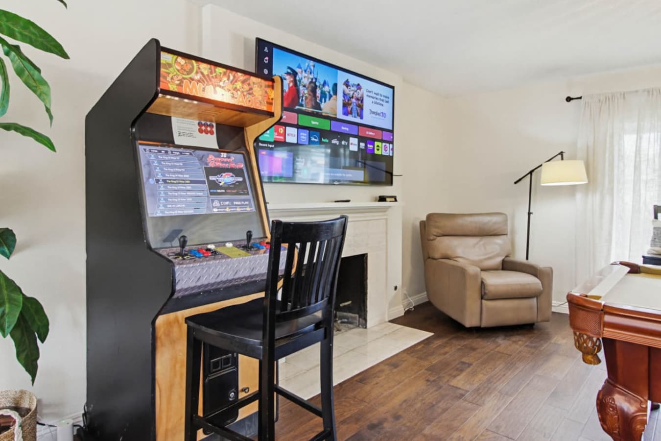Arcade setup w/ game machines & chair for hours of indoor entertainment
