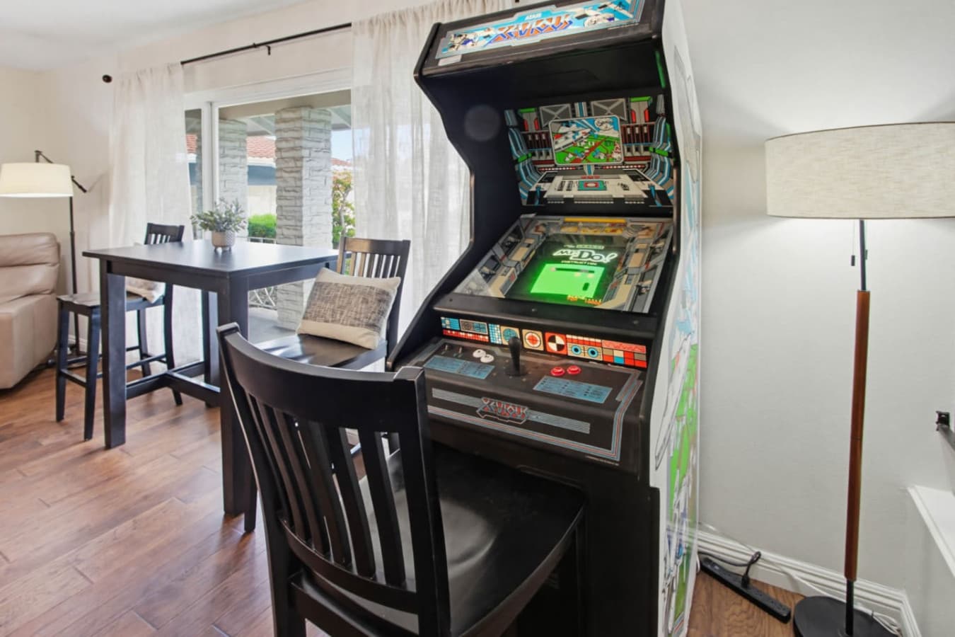 Arcade game setup beside seating area, perfect for casual indoor fun