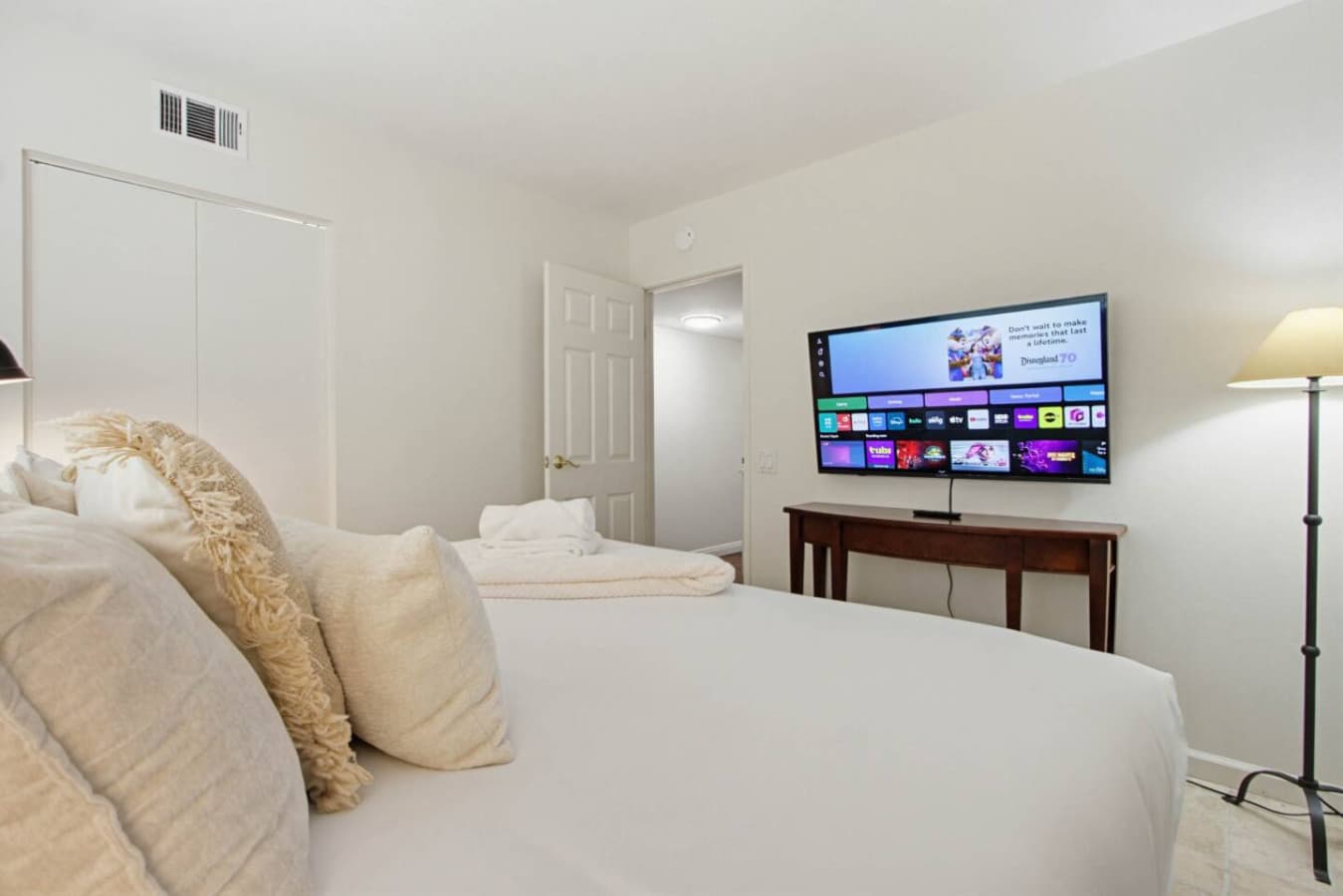 Bright bedroom w/ bed, TV & soft lighting for relaxed evenings in