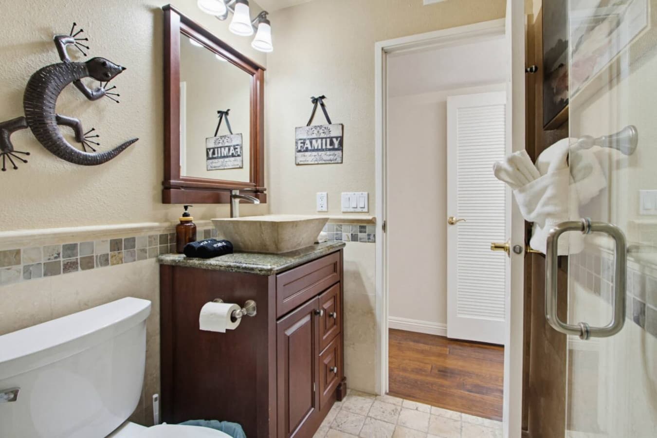 Bathroom w/ sink, mirror & glass shower, designed for easy daily routines