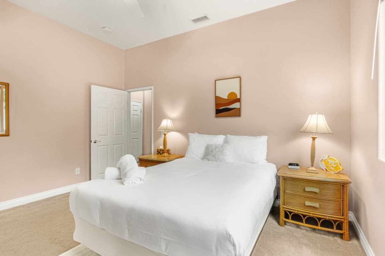 Cozy bedroom setup featuring soft lighting, matching nightstands, and a peaceful, uncluttered feel.