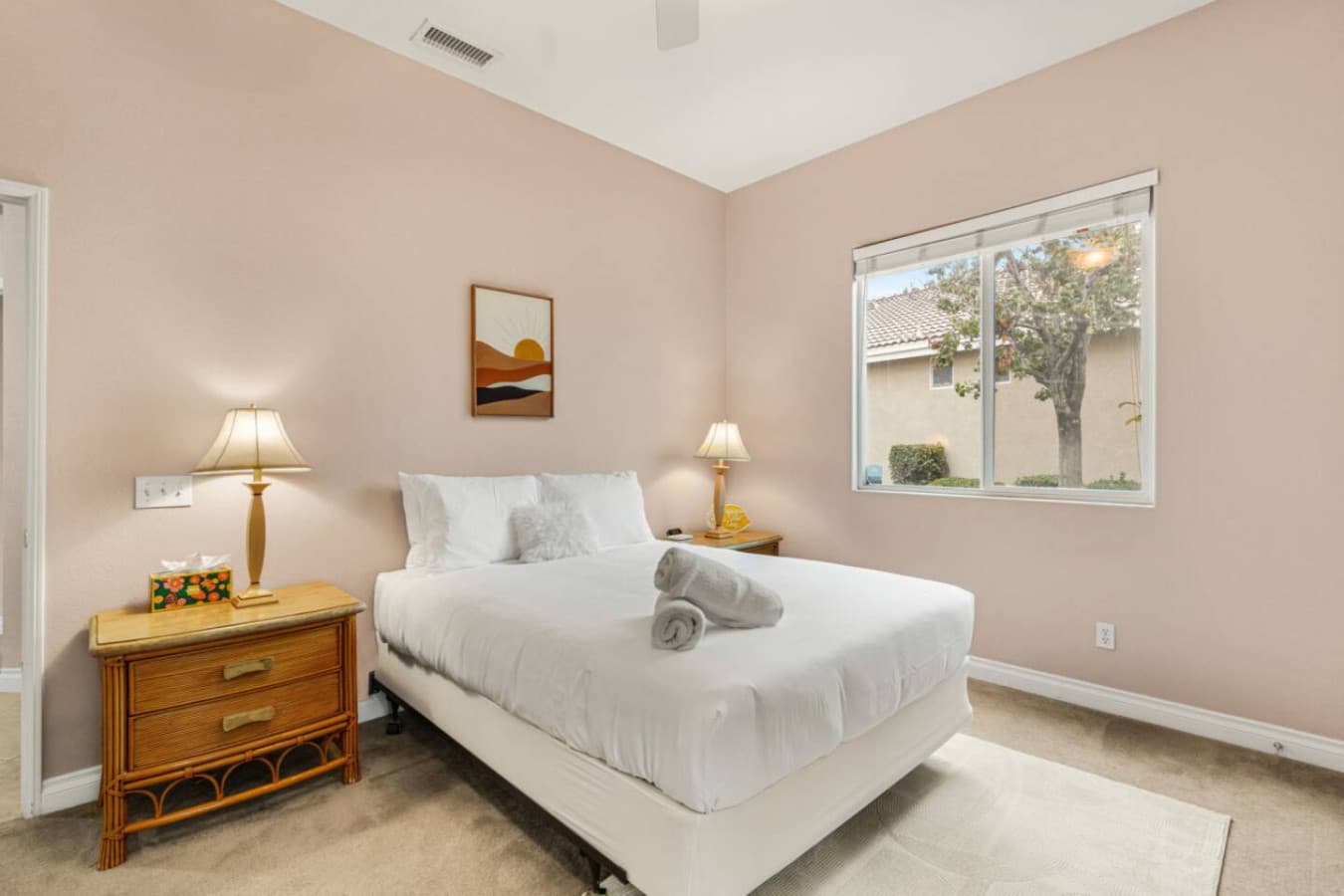 Bright bedroom w/ natural light, neutral tones, and a simple layout made for restful nights.