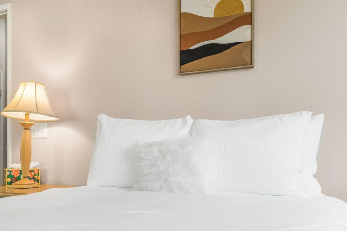 Close-up of plush pillows and clean bedding that set the tone for a comfortable stay.
