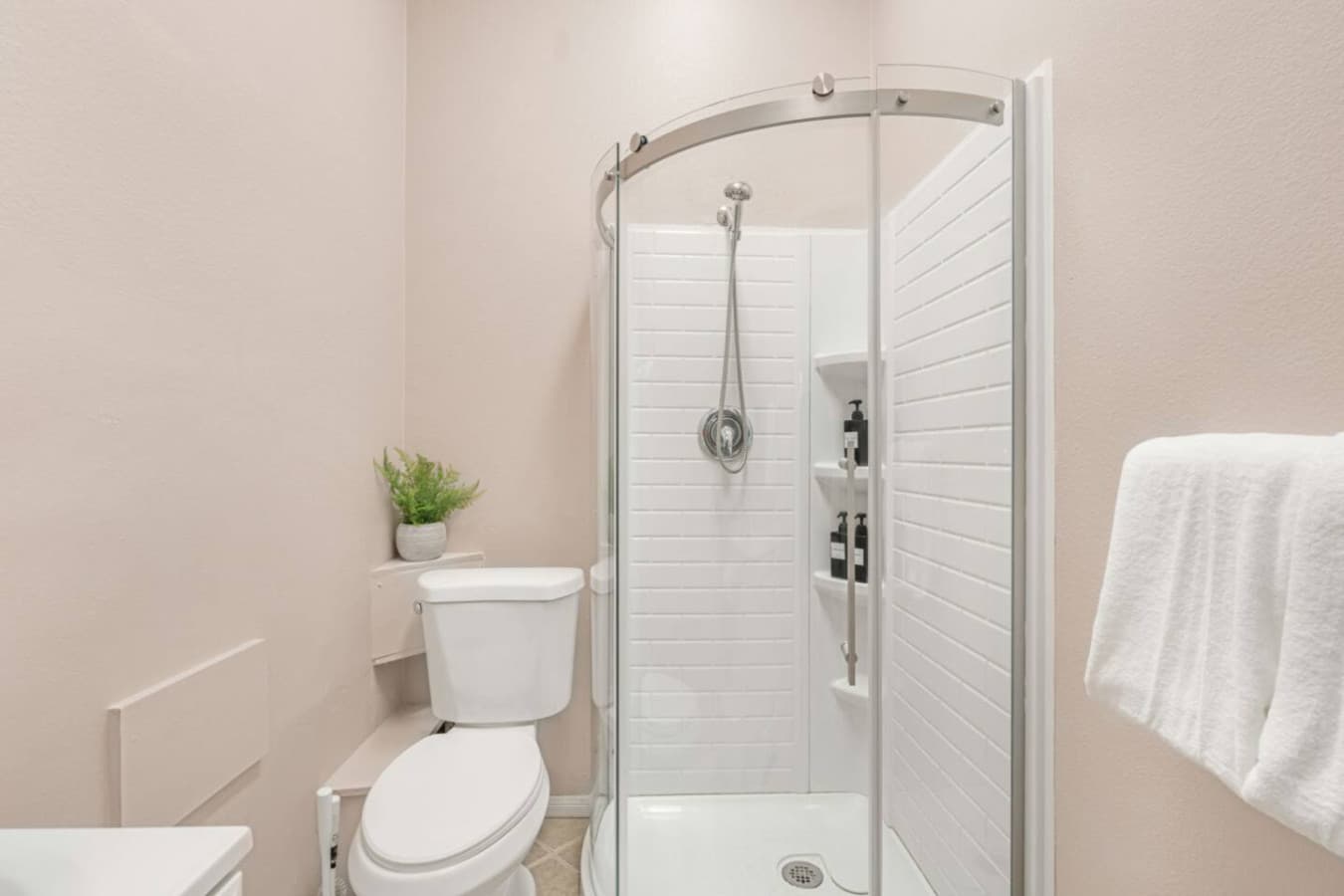 Additional bathroom view w/ shower, fresh towels, and clean finishes throughout.