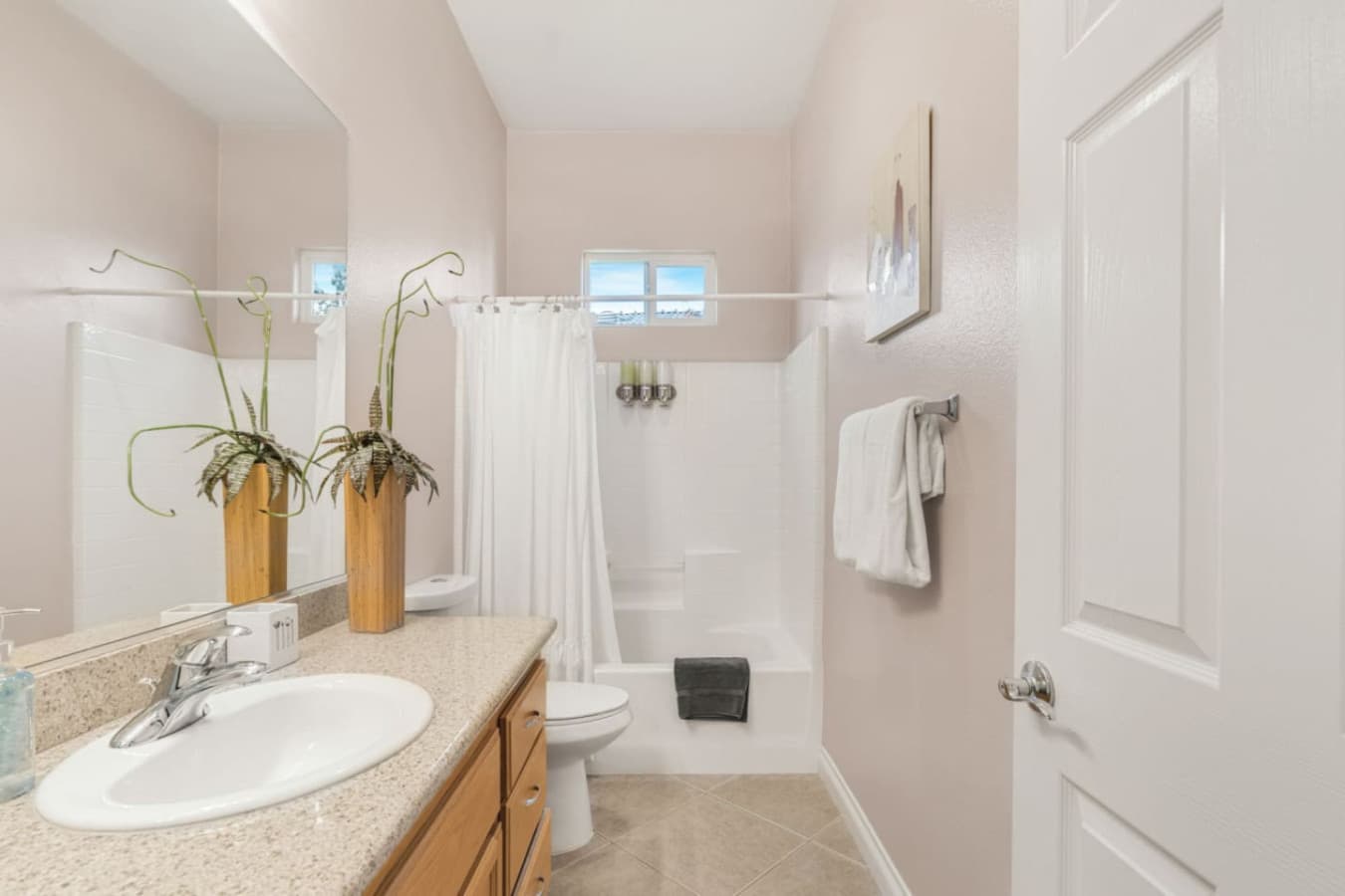 Bathroom w/ sink, mirror, and thoughtful details that keep the space bright and functional.