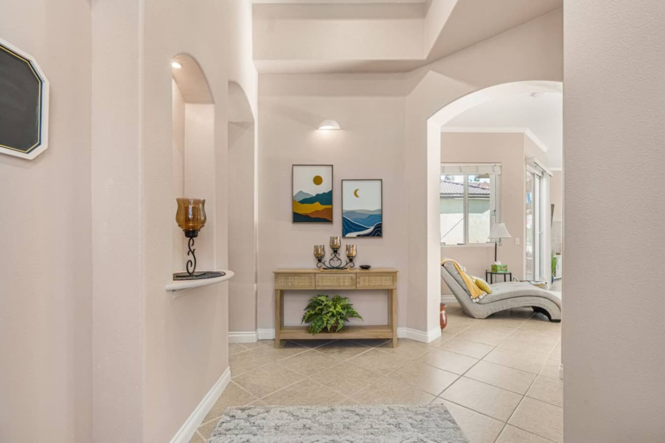 Entry hallway w/ warm tones and smooth flow leading straight into the heart of the home.