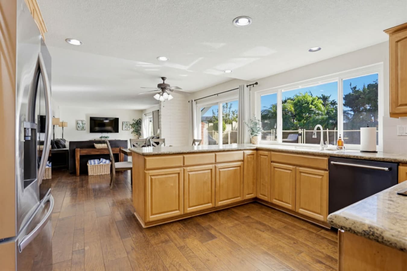 Open kitchen w/ island seating, flowing into the living area for effortless gathering