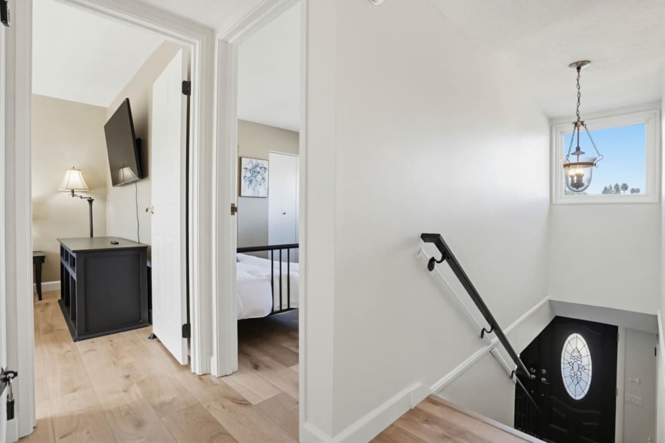 Hallway w/ staircase leading to bedrooms, offering easy access between levels