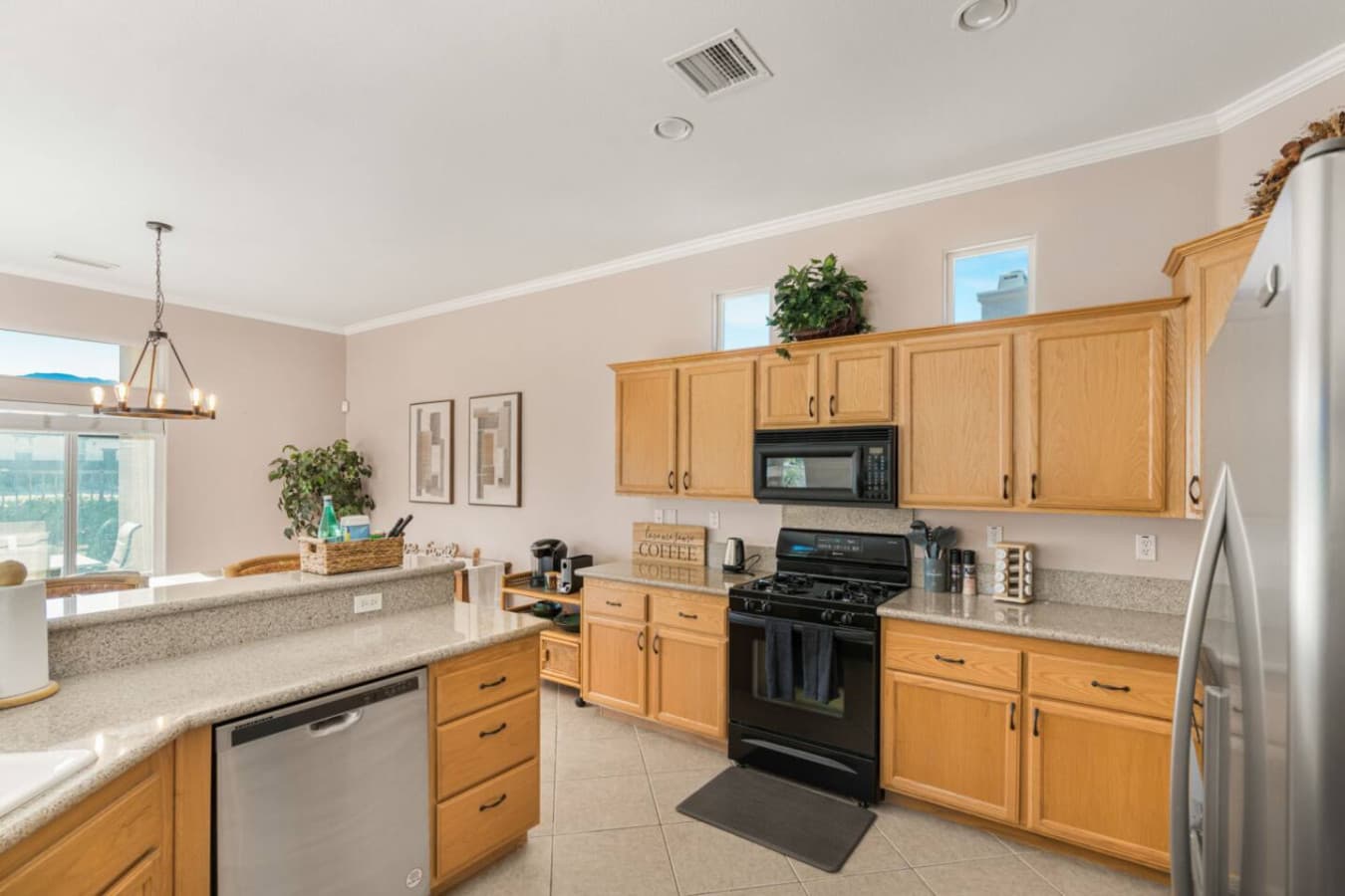 Kitchen view w/ warm wood cabinets and open layout that keeps cooking part of the fun.
