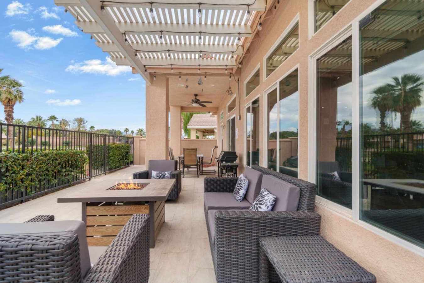 Outdoor dining area w/ seating and shade, ideal for long meals and relaxed gatherings.