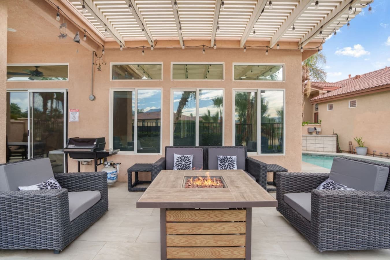 Outdoor dining area w/ seating and shade, ideal for long meals and relaxed gatherings.