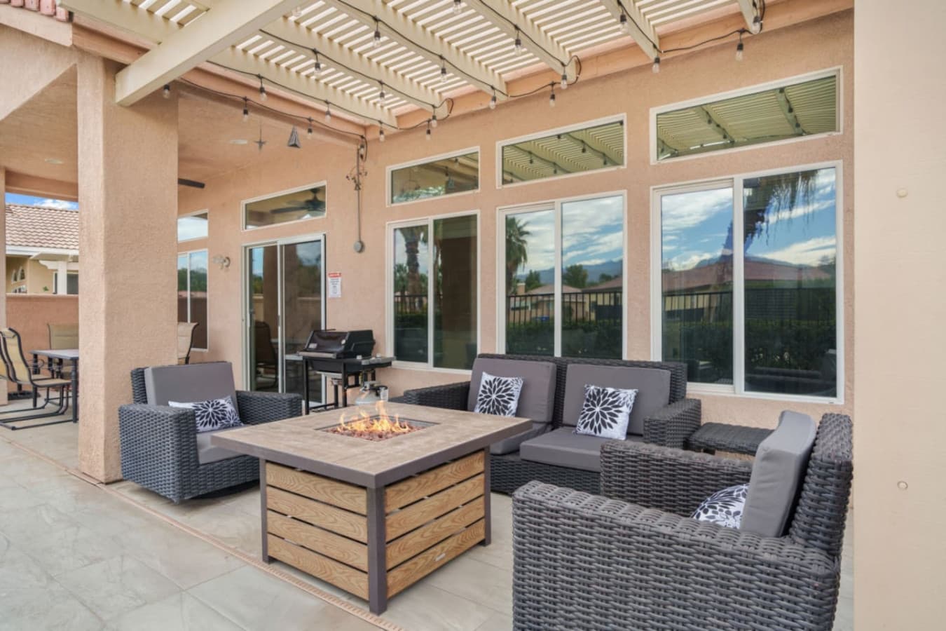 Outdoor dining area w/ seating and shade, ideal for long meals and relaxed gatherings.