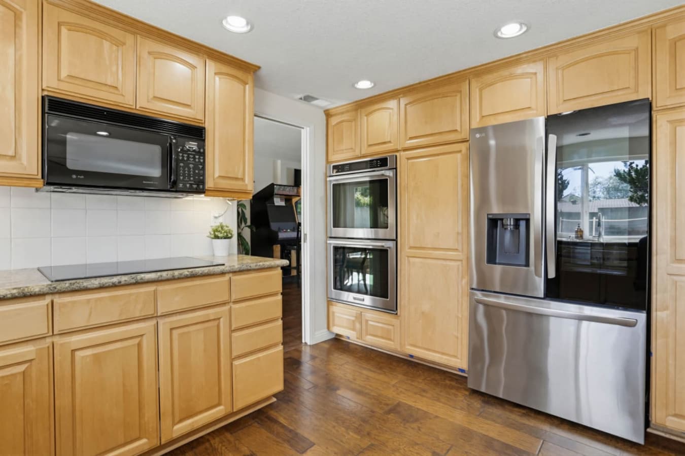 Spacious kitchen w/ double ovens, ample cabinetry & room for cooking together