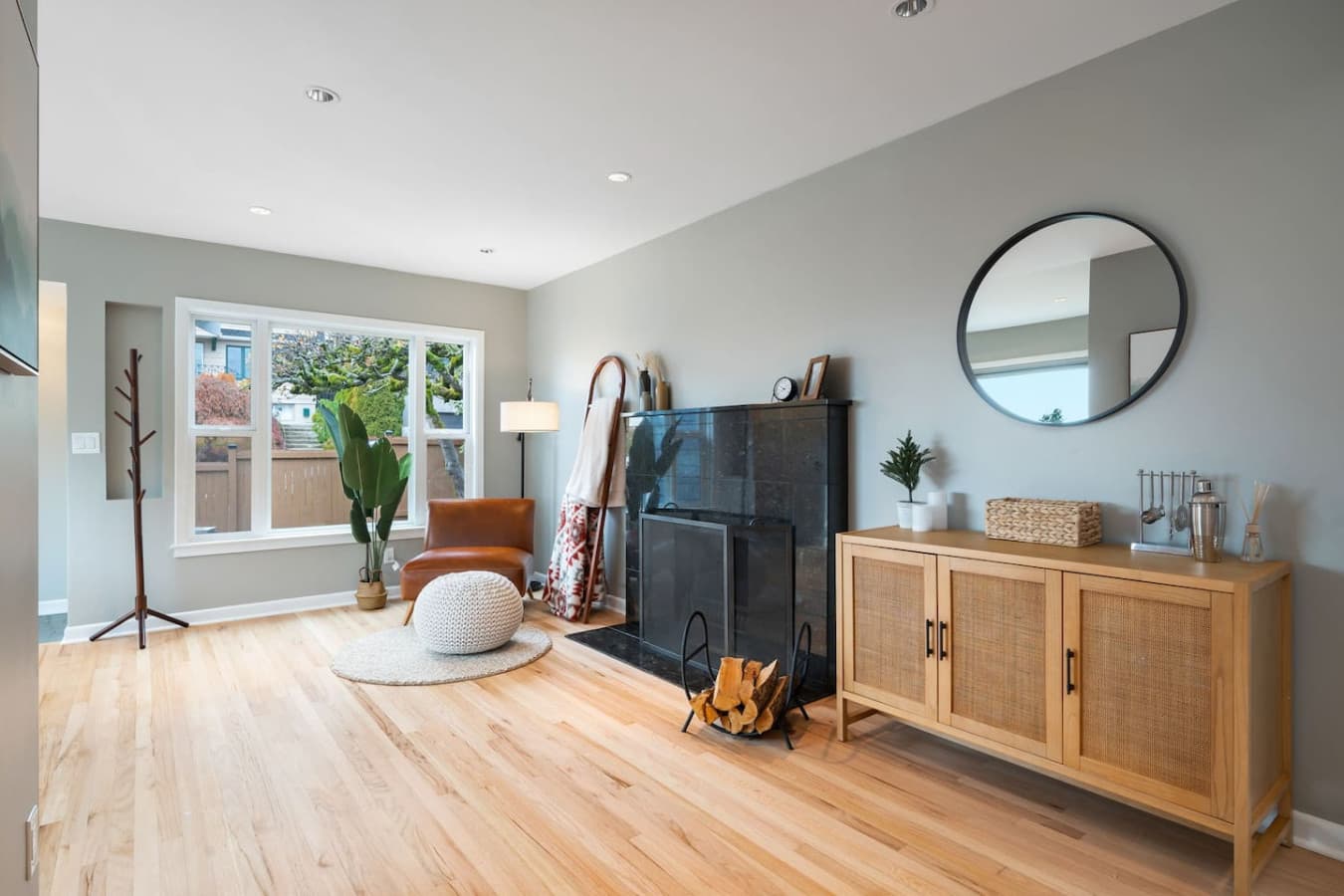MAIN FLOOR: A cozy corner near the living room, featuring a black marble fireplace and a stylish bar area perfect for preparing drinks and unwinding in comfort.
