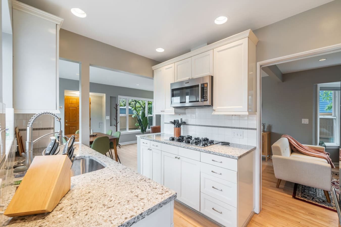 MAIN FLOOR KITCHEN: The functional and stylish kitchen is designed to make cooking a pleasure. It features a spacious refrigerator, built-in oven, gas cooktop, microwave, and dishwasher.