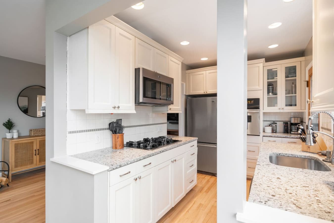 MAIN FLOOR KITCHEN: The functional and stylish kitchen is designed to make cooking a pleasure. It features a spacious refrigerator, built-in oven, gas cooktop, microwave, and dishwasher.