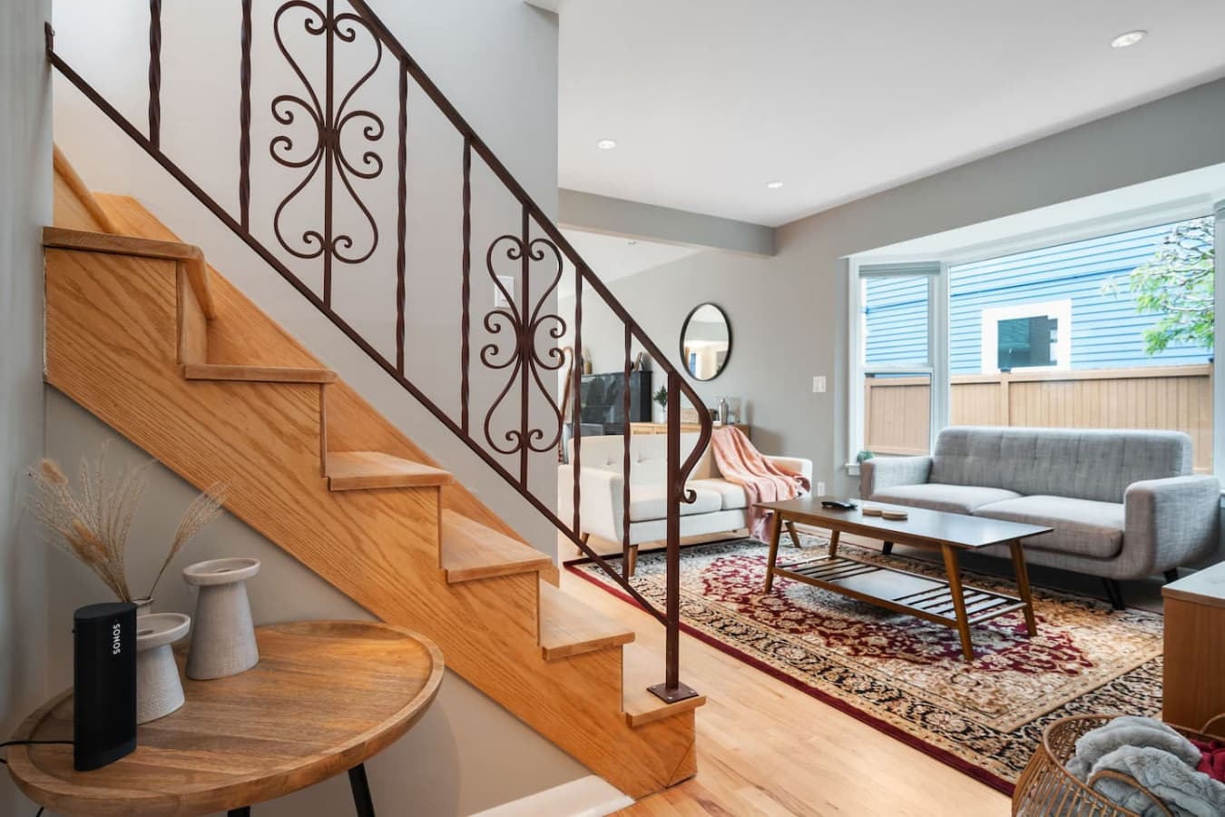 MAIN FLOOR: Blending European and Mediterranean influences, this staircase features an ornate wrought-iron railing and warm oak steps. It leads guests to the second floor, where the bedrooms and bathroom are located.
