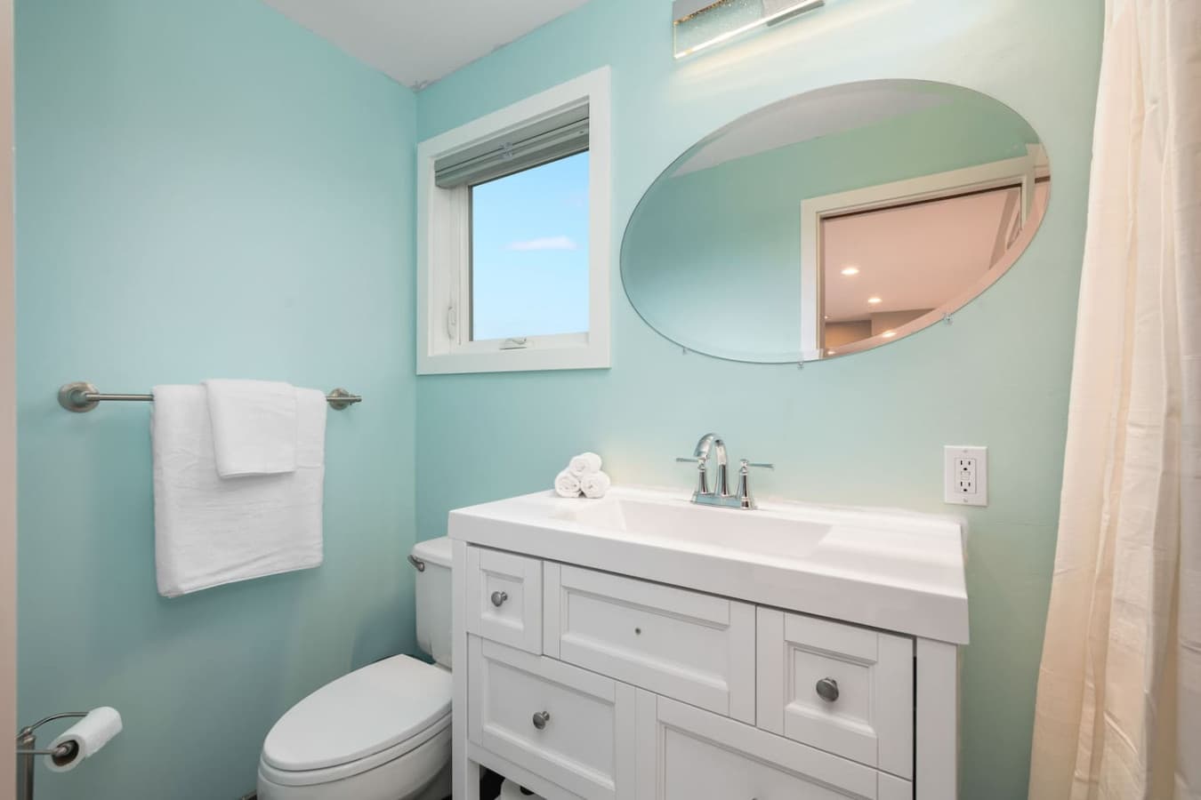 UPSTAIRS - The private bathroom provides modern comfort and convenience, boasting a spacious shower, high-quality fixtures, and plush towels.