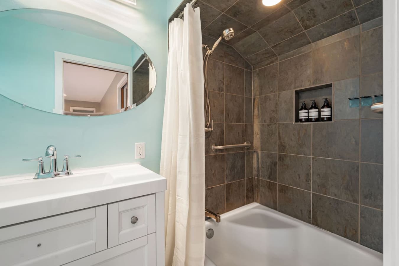 UPSTAIRS - The private bathroom provides modern comfort and convenience, boasting a spacious shower, high-quality fixtures, and plush towels.