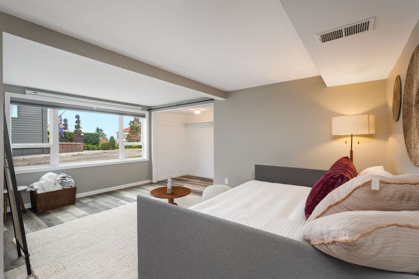 DOWNSTAIRS BEDROOM: This room combines comfort and functionality, featuring a stylish sofa bed with decorative cushions, perfect for relaxation. The projector screen also offers entertainment options for movie night!