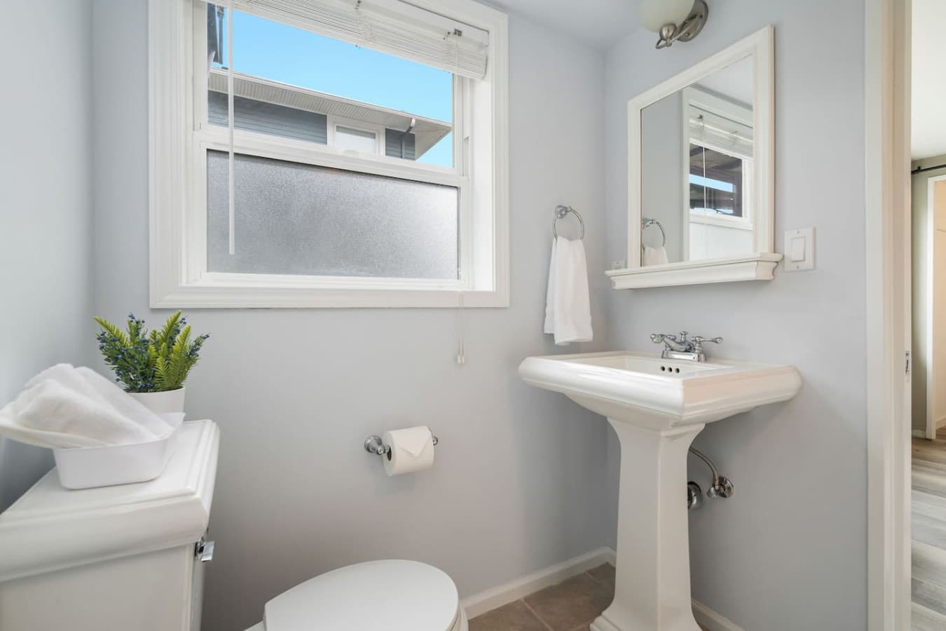 DOWNSTAIRS: The en-suite bathroom has a full bathtub and shower combo with shampoo, conditioner, and gel soap.