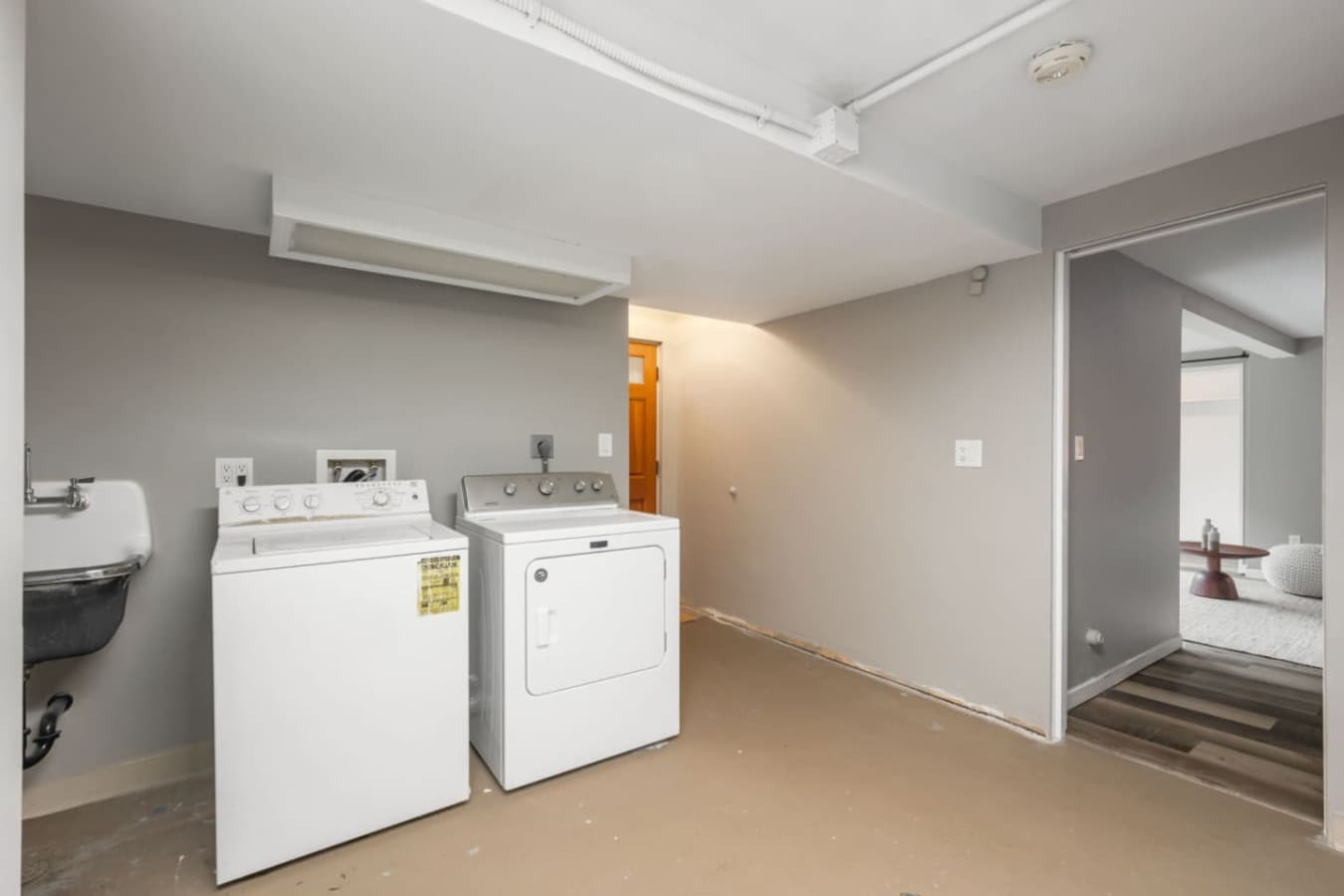 DOWNSTAIRS: Laundry room - Washing and drying machine and laundry detergent.