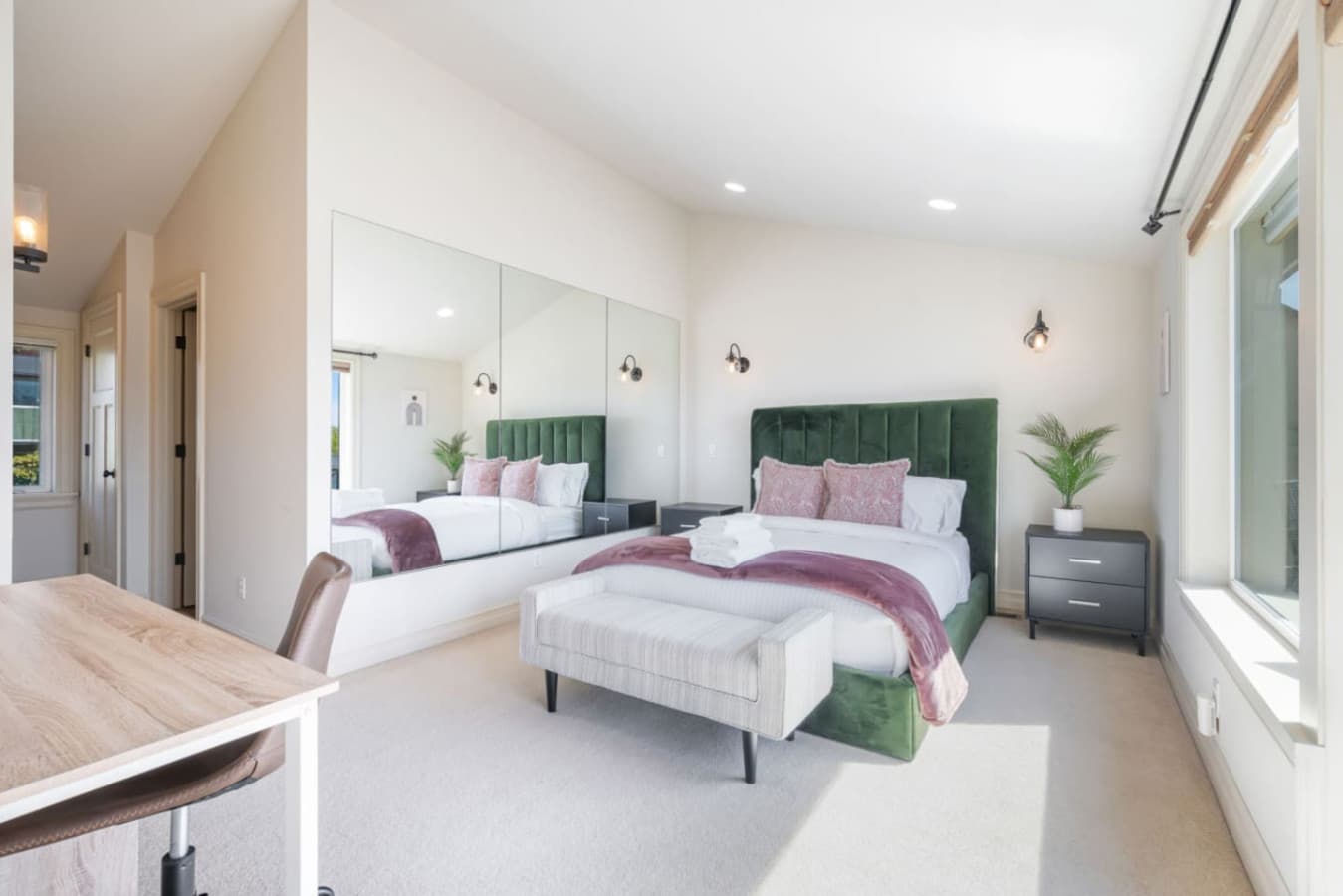 3rd FLOOR MASTER BEDROOM: The master bedroom offers a queen-size bed, portable air conditioner, workspace, TV, private bathroom, balcony access, and curtains for added privacy.