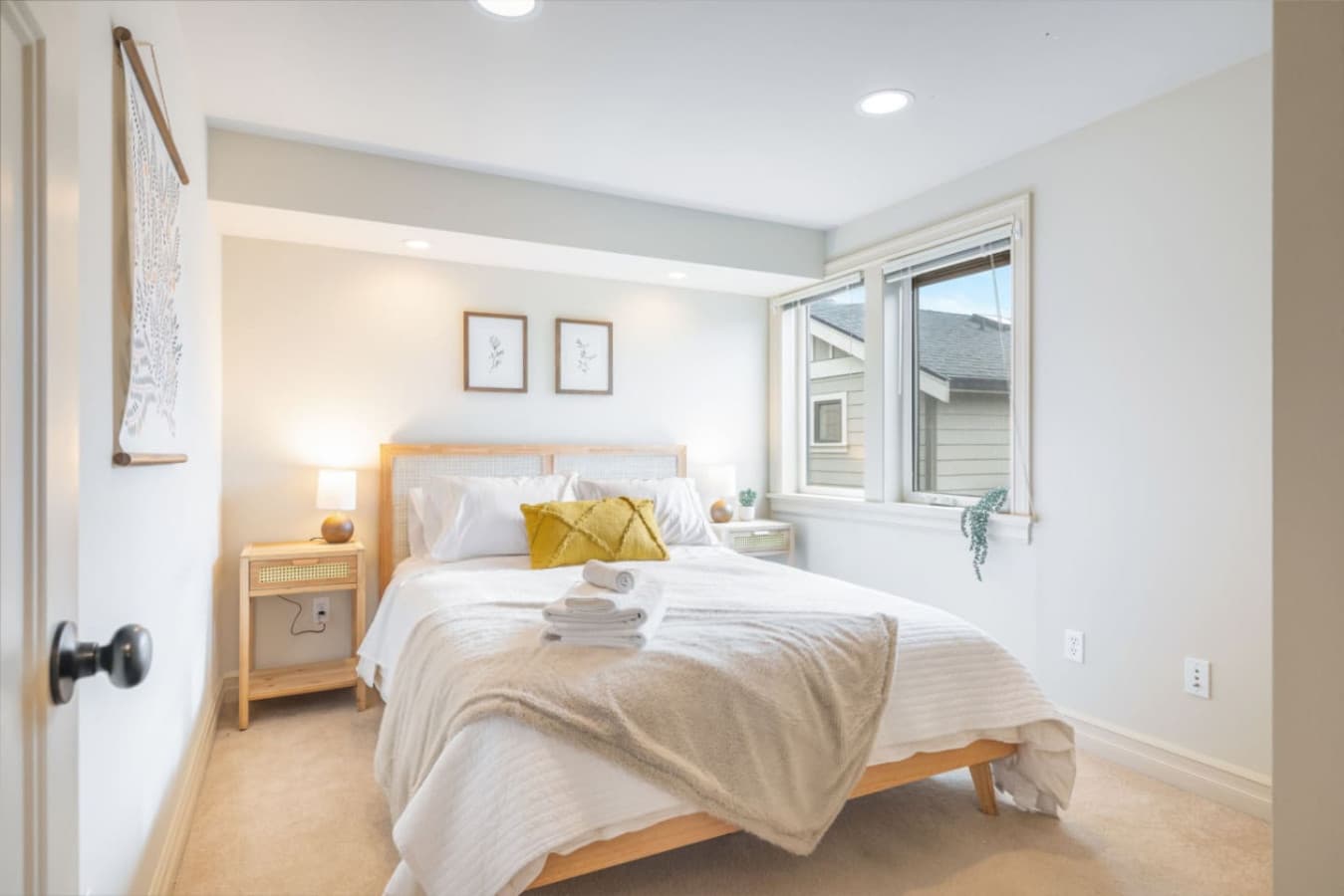 2nd FLOOR BEDROOM 1: This elegant room has great natural light, and features a queen-size bed, neutral décor, and ample closet space.