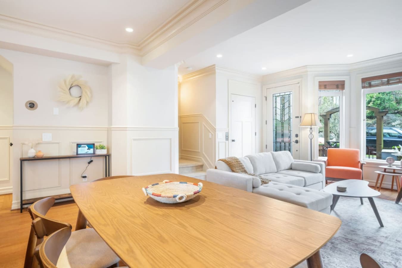 From this wide angle, you can see the open-concept space and the staircase leading to the second floor.