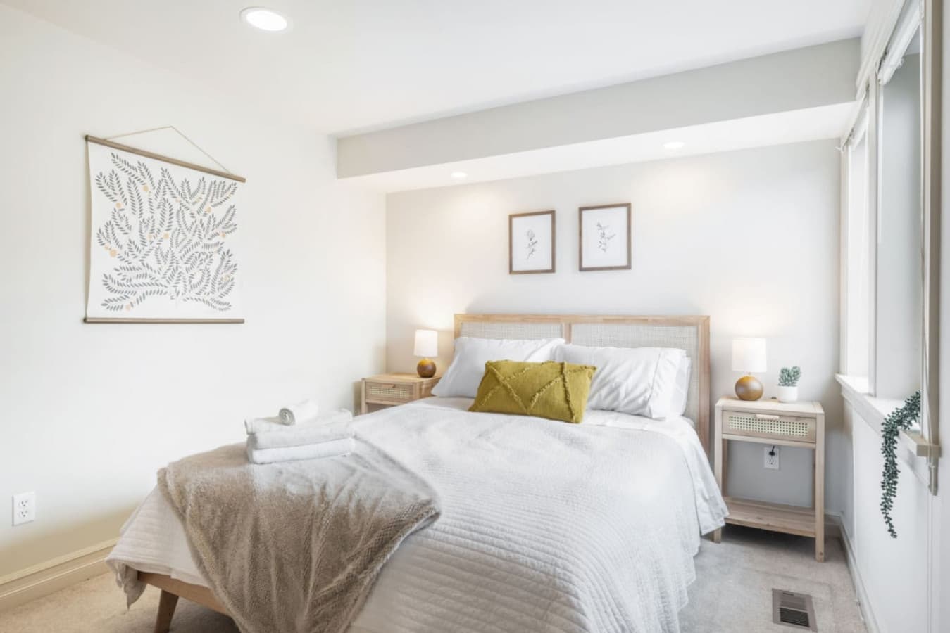 2nd FLOOR BEDROOM 1: This elegant room has great natural light, and features a queen-size bed, neutral décor, and ample closet space.